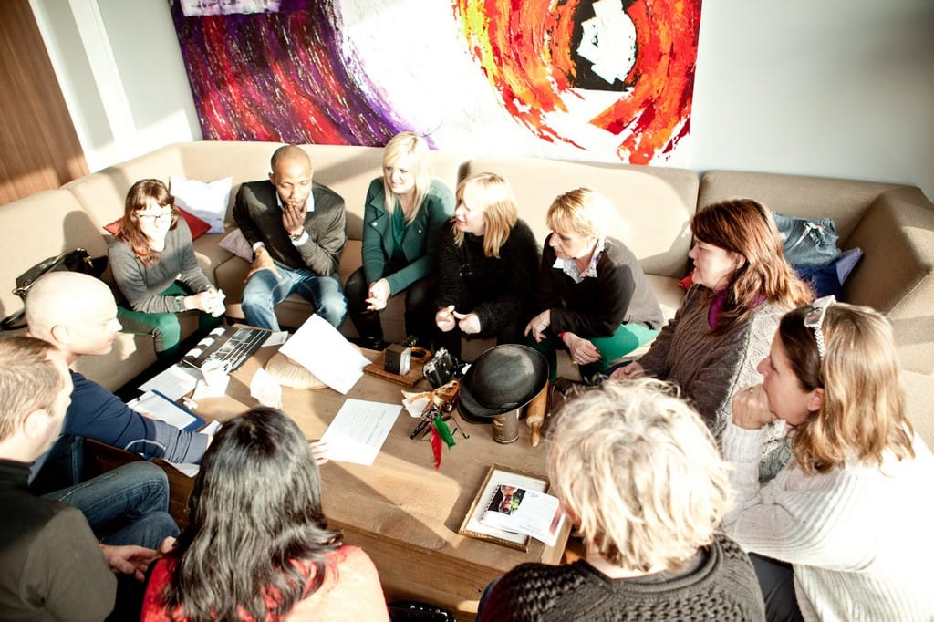 Office-based and home-working colleagues forming one team together during an activity